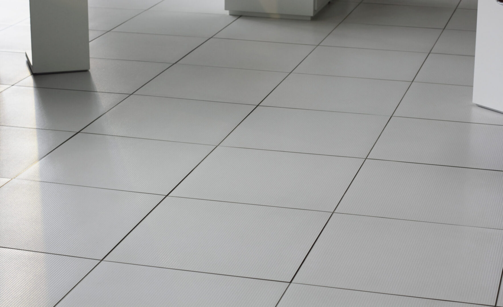 White tiled floor in a modern setting.
