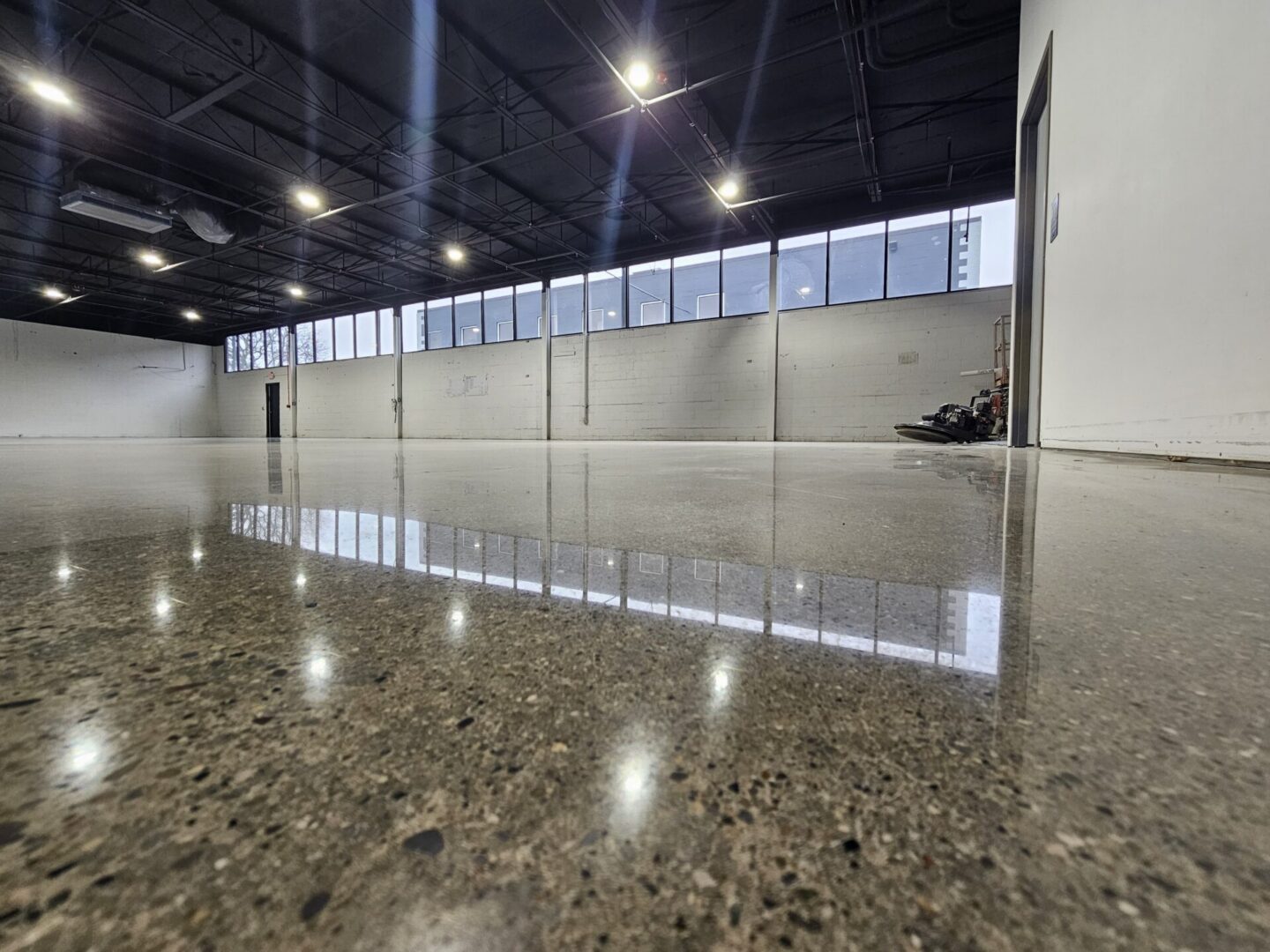 Empty warehouse with polished concrete floor.