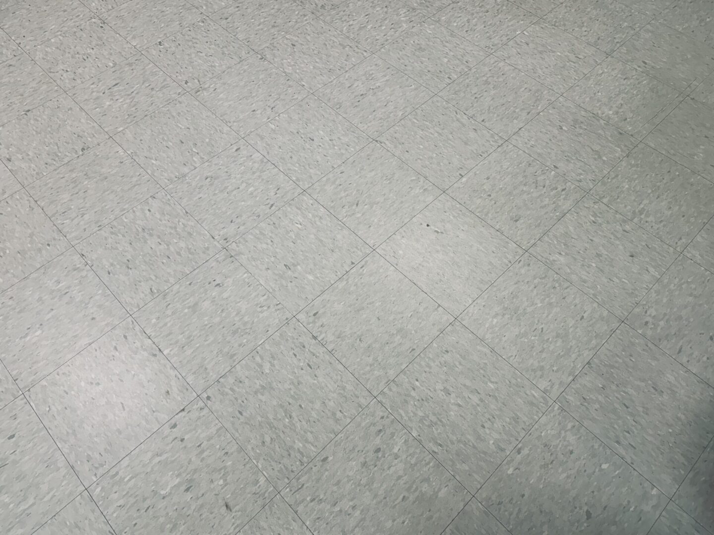 Gray tiled floor with subtle texture pattern.