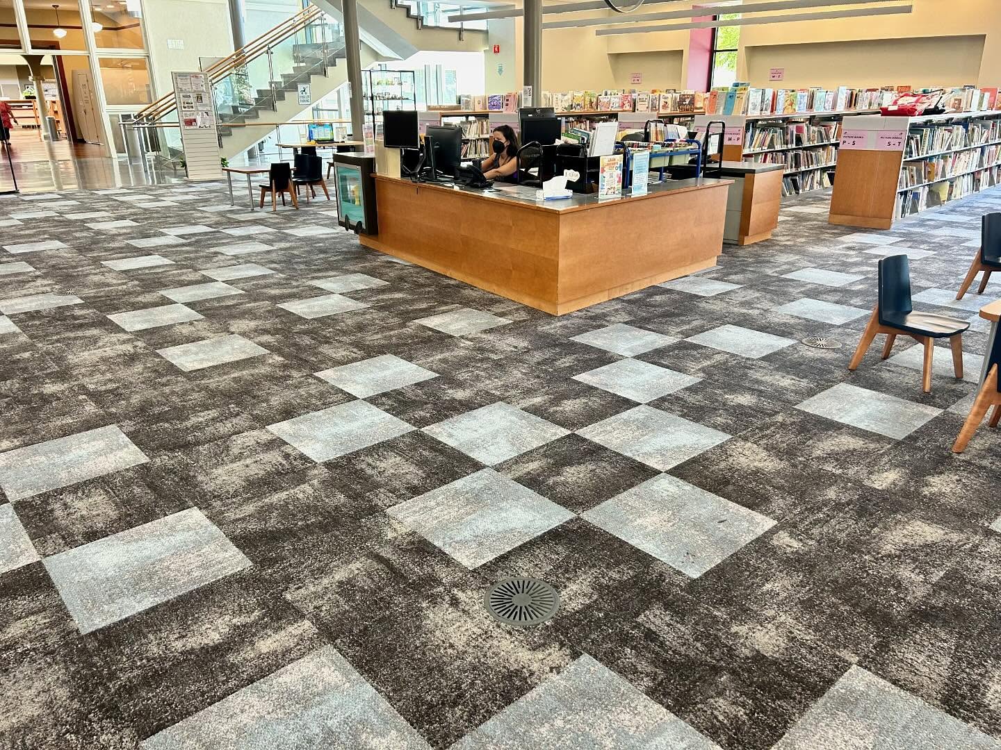 Librarian at service desk in public library
