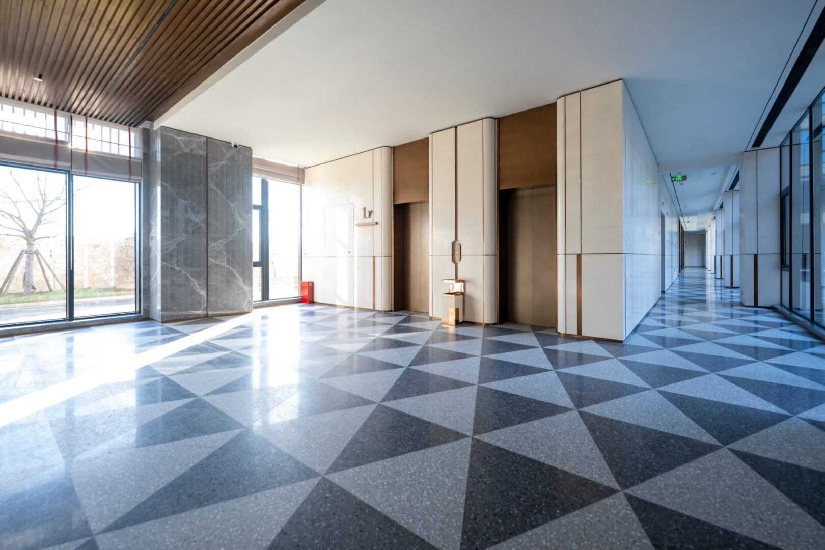 Modern building lobby with geometric floor tiles.